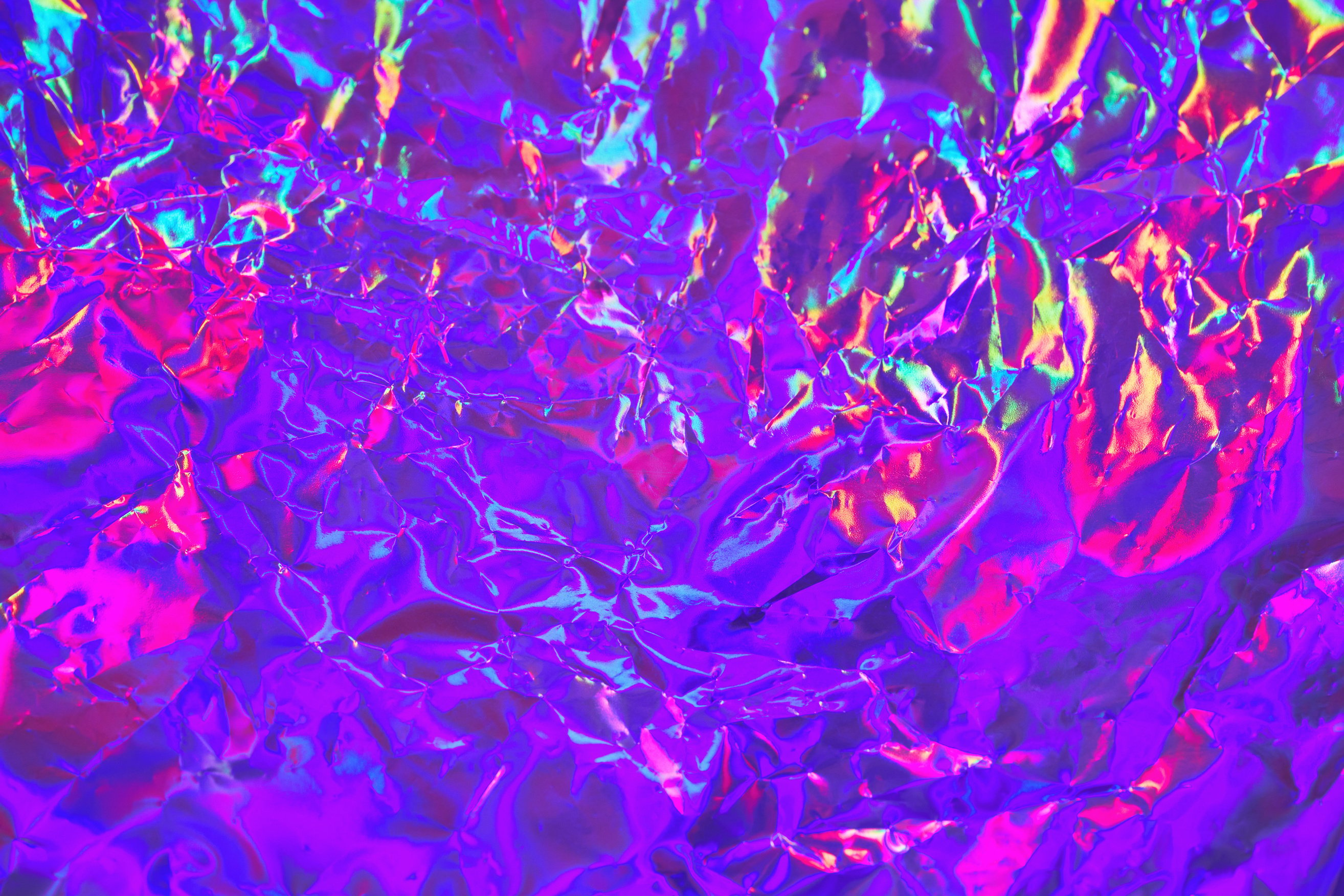 Abstract neon holographic metallic foil background in 80s, 90s style